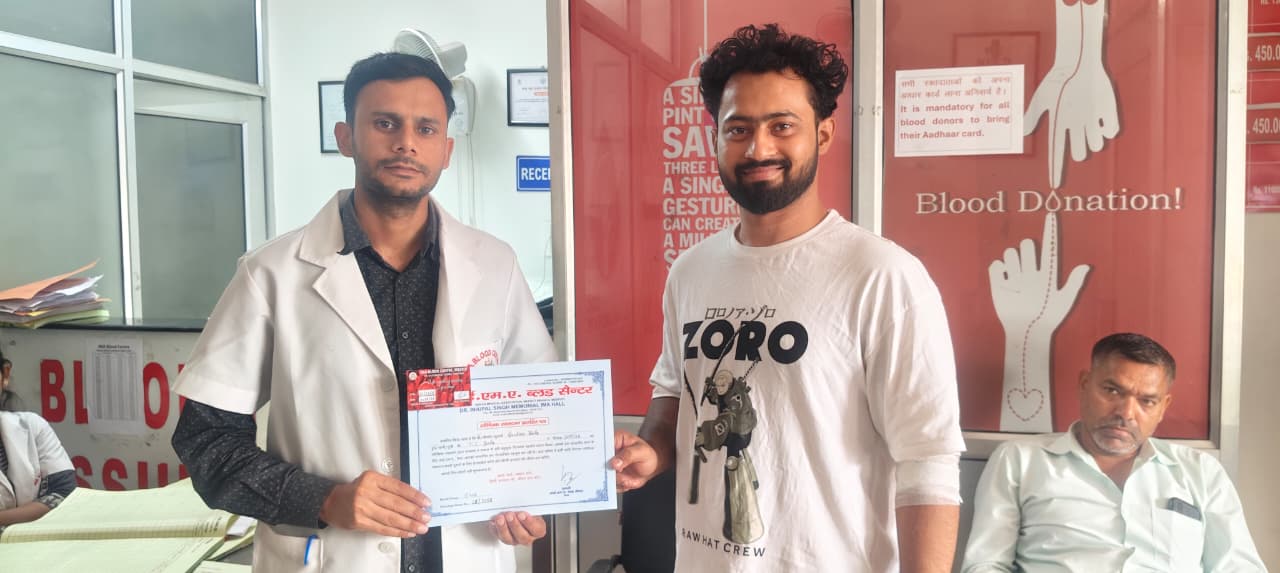 Doctor presenting certificate to voluntary blood donor in Meerut