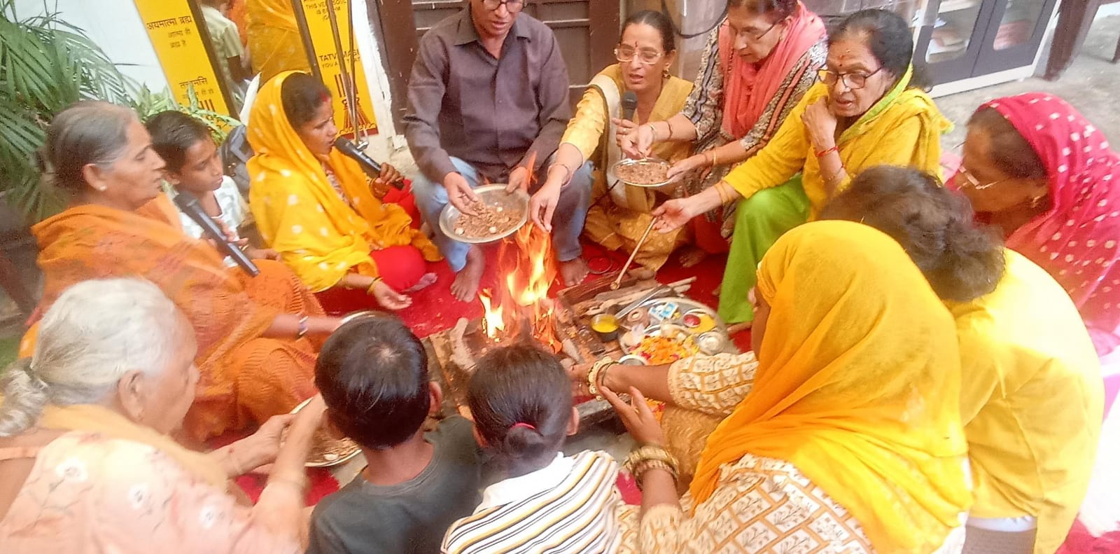 Devotee families chanting Gayatri Mantra at sacred holy fire in Meerut
